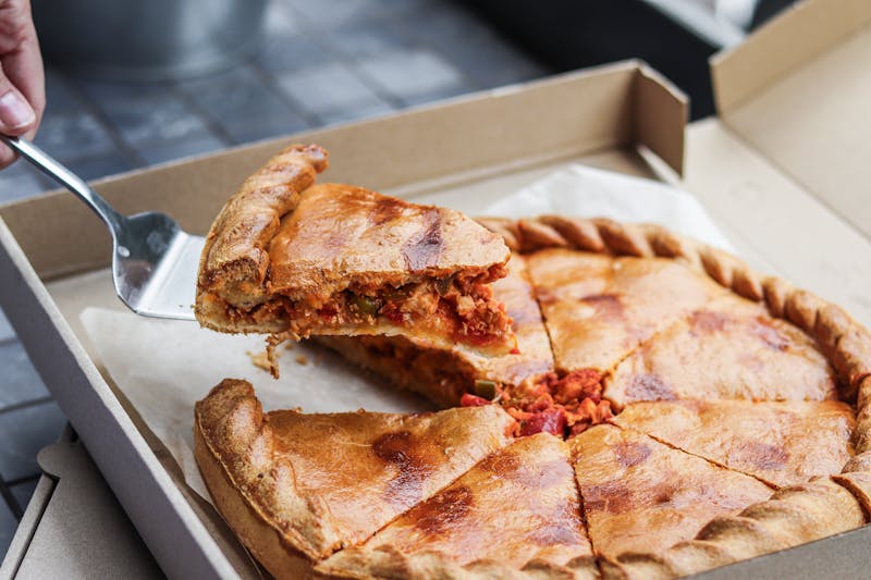 Pequod's pizza kitchen team working together