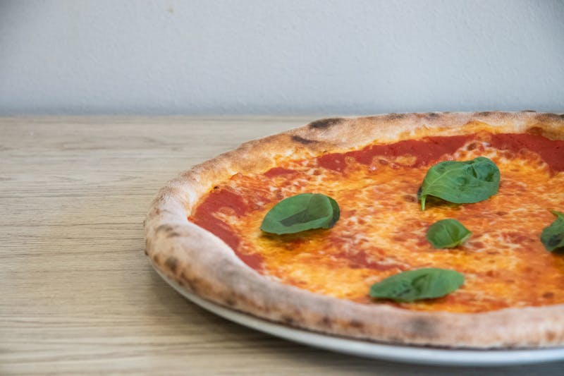 Margherita thin crust pizza with fresh basil